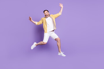 Photo of funky childish age gentleman wear striped shirt spectacles jumping high smiling isolated violet color background