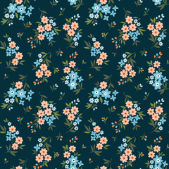 Beautiful floral pattern in small abstract flowers. Small coral and blue flowers. Blue background. Ditsy print. Floral seamless background. The elegant the template for fashion prints. Stock pattern.