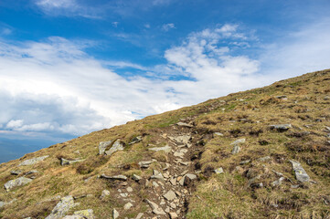 Fototapeta premium Trail up the mountain against the background of blue sky