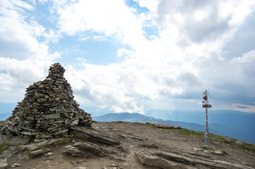 Fototapeta premium A pile of stones on a mountain top in the carpathian mountains in summer