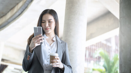 Obraz premium Happy Confident young asian businesswoman use the smartphone. business successful technology