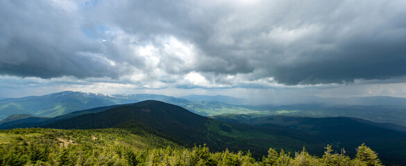 Panorama of the Carpathian mountains at the beginning of summer in Ukraine, rest and travel in the mountains