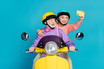 Photo of grey haired retired pensioner husband wife couple people wear helmet rider make selfie...