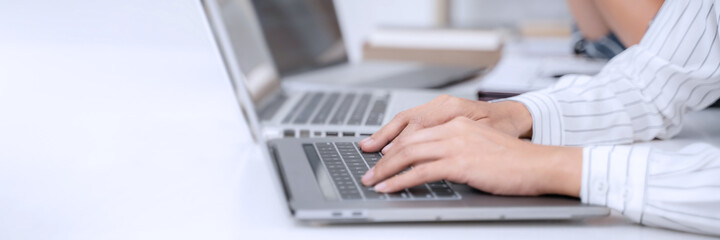 programmer writing program code with two monitors and working on a new software or hacker...