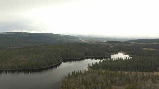 Aerial View of a Lake in the Canadian Landscape. Cloudy and Sunny Spring Day. Taken near Kamloops and Merritt, British Columbia, Canada.