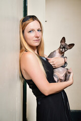 Beautiful blonde woman with a sphynx cat