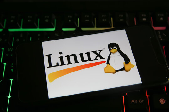 Viersen, Germany - June 9. 2021: Closeup of mobile phone screen with logo lettering of linux on computer keyboard