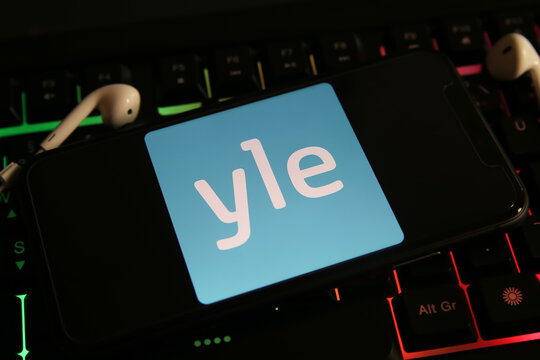 Viersen, Germany - June 9. 2021: Closeup of mobile phone screen with logo lettering of finland yle suomi radio station on computer keyboard
