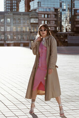 Obraz premium Beautiful young caucasian woman wearing trench coat