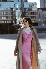 Obraz premium Beautiful young caucasian woman wearing trench coat