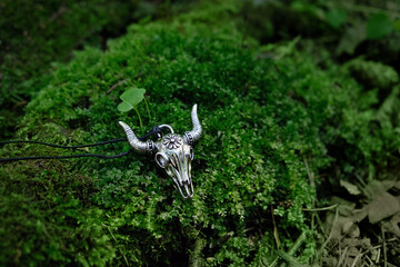 bull skull amulet, Wizards Pendant on natural moss background. Paganism Occult symbol. Magic...