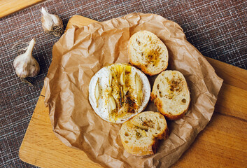homemade DIY baked camembert with garlic.cheese with white mold.baked cheese.