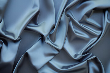 Elegant soft abstract gray background. Delicate silk waved fabric with copy space for design projects. Toned image.
