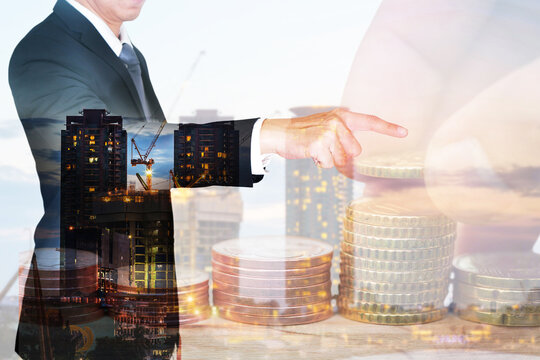 double exposure of Euro Coin stacks on table, businessman point goal,construction crane and building as business, investment,currency, exchange rate and industrial concept