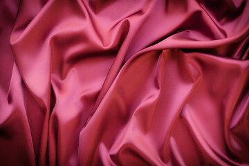Elegant soft abstract red background. Delicate silk waved fabric with copy space for design projects