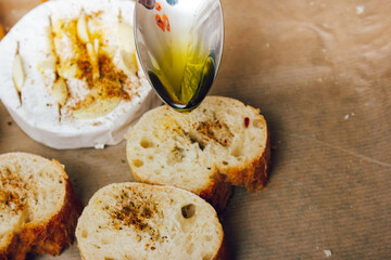 DIY baked cheese camembert instruction step by step. step 4 add olive oil. cheese with white...