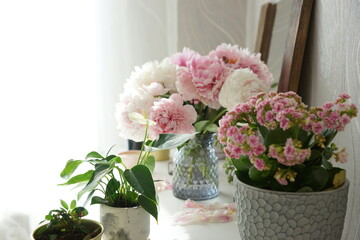 Bouquet of pink peonies on the dresser in the bedroom