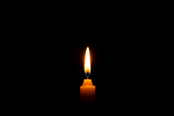 Close-up of One candle burning flame on a black background - isolated, macro.	