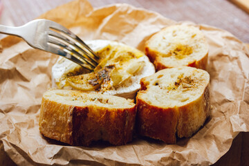 DIY baked cheese camembert instruction step by step. step 5 Camembert tasting. melted cheese stretches. cheese with white mold.moldy cheese