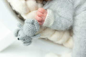 hands of a newborn. a knitted toy in a child's hand