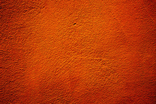 Orange colored abstract wall background with textures of different shades of orange and orange red
