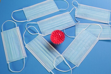 Viral Coronavirus Bacteria And Protective Medical Disposable Masks On A Blue Background. Concept Of...
