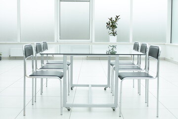 Laptop on glass table in spacious office space