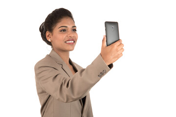 Beautiful young businesswoman using smartphone to take selfie photo isolated on white background