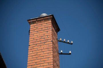 Old brick chimney with porcelain power cable isolations in Stockholm
