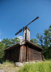Fototapeta na wymiar Old wind mill on display in a park in Stockholm
