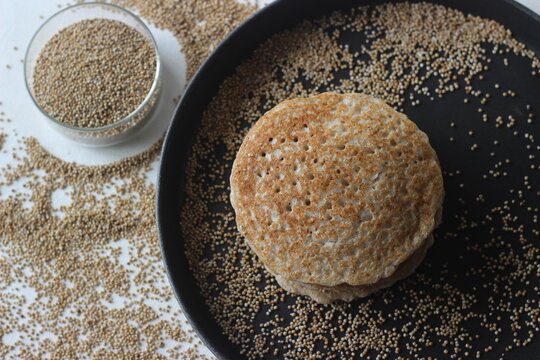 Kodo millet pancakes. Pancake made with a fermented batter of kodo millet, flattened rice and coconut.