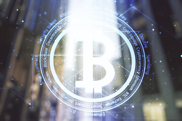 Virtual Bitcoin hologram on office buildings background. Multiexposure