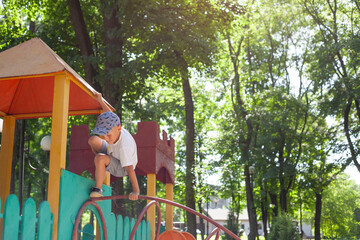 Children play in the playground. Amusement park. Leisure activities of little friends in the park.