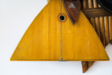 Wooden russian balalaika musical instrument on the wall