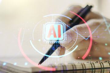 Double exposure of creative artificial Intelligence abbreviation with woman hand writing in notepad on background. Future technology and AI concept