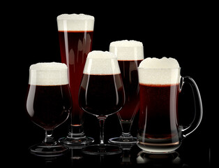 Set of fresh stout beer glasses with bubble froth isolated on black background.