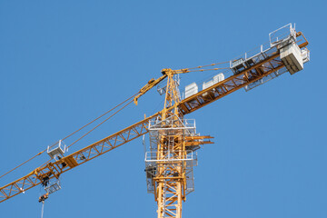 Jardin, Antioquia, Colombia. October 15, 2020: Yellow tower crane and blue sky in southwest Antioquia.