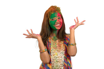 Portrait of a happy young girl with a colorful face on Holi color festival on white background