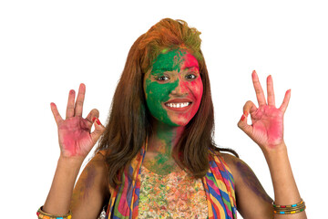 Portrait of a happy young girl with a colorful face on Holi color festival on white background