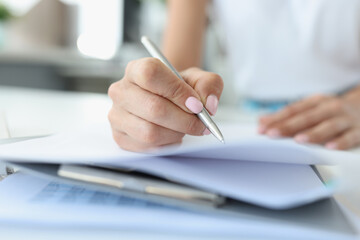 Woman hand makes entries in diary closeup