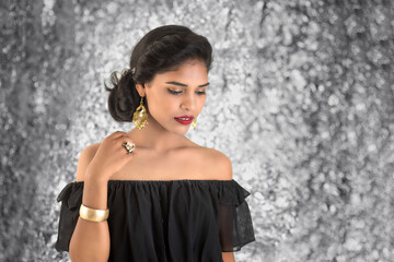 Naklejka premium Portrait of beautiful young Girl. Closeup face of a pretty Indian model on texture background