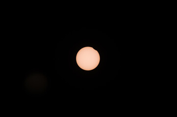 Partial solar eclipse, the sun with a small bite from the solar disk from the Netherlands