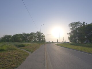 Fototapeta premium sun and reflecting asphalt road, sun landing to the road