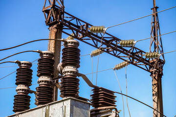 Power transmission tower with electric garland of insulators on transformer station - obrazy, fototapety, plakaty