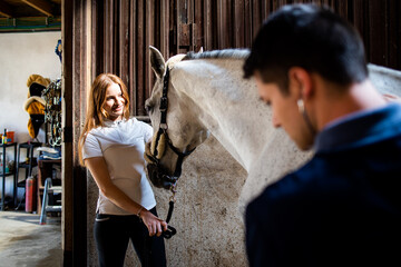 Fototapeta na wymiar Vet checking horse's health before riding.