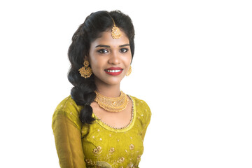 Portrait of beautiful traditional Indian girl posing on white background.
