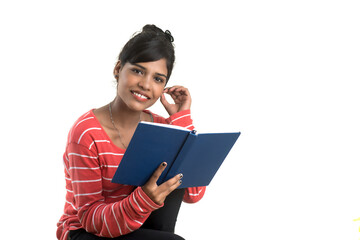 Fototapeta premium Pretty young girl holding book and posing on white background