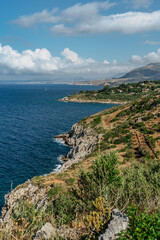 Fototapeta na wymiar Beach vacation in Italy, Sicily, turquoise water,sandy beaches,hiking trails.Holiday paradise travel scenery.Scenic coastline of Zingaro Nature Reserve with rocks.Beautiful lagoons with clear water