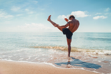 A muay thai or kickboxer training with shadow boxing outdoor at seashore © ZaStock