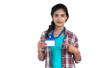 Young woman holding Identification white blank plastic id card.